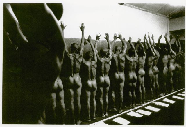 Mineworkers stripped naked and lined up for inspection. A Peter Magubane classic.