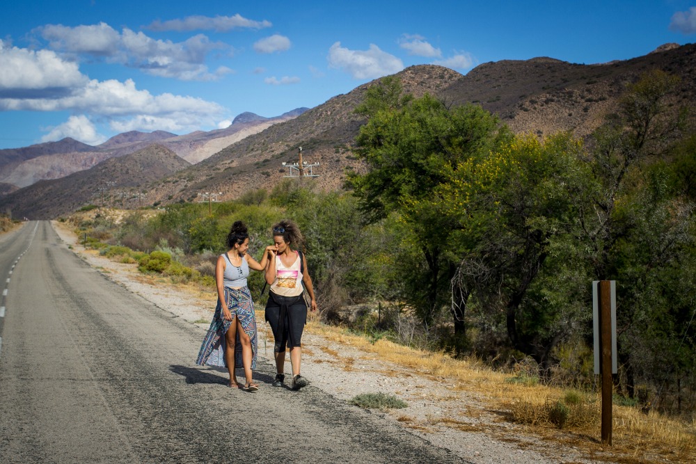 Sarah Summers greets her partner Kelly-Eve Koopman on the road after her walk along the R407 towards Prince Albert from Willowmore, Western Cape, South Africa, February 22, 2017. Koopman and Summers are creators of the Coloured Mentality web series and are making a documentary about the walk. Photo: Jane Berg. 